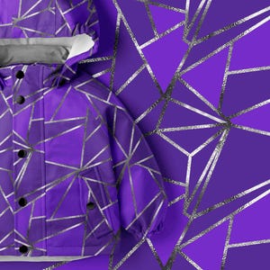 May include: A purple hooded jacket featuring a geometric pattern of intersecting silver lines. The jacket includes a front placket with black circular buttons, long sleeves with elastic cuffs, and a light gray interior lining visible at the collar.