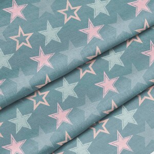 May include: A teal fabric featuring a repeating pattern of five-pointed stars in alternating shades of soft pink and pale mint green. The stars have a textured, hand-drawn appearance with visible outlines, set against a solid muted teal background.