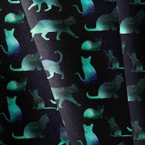 May include: A black fabric featuring a repeating pattern of cat silhouettes in various poses. Each cat shape is filled with a vibrant teal and blue galaxy-inspired gradient, displaying a speckled texture that resembles distant stars in space.
