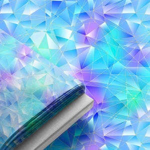 May include: A folded stack of fabric featuring a geometric pattern of triangles in shades of blue, cyan, and purple. The design includes thin, intersecting gold lines that form a network across the surface, creating a faceted, crystalline appearance.