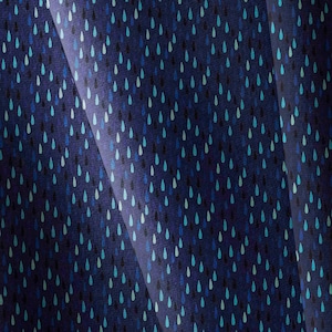 May include: Navy blue fabric featuring a repeating pattern of teal, light blue, and black teardrop shapes. The fabric has a subtle texture and a slight sheen, with folds creating shadows and highlights.