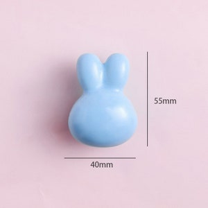 May include: A light blue ceramic bunny-shaped knob, measuring 40mm wide and 55mm tall.