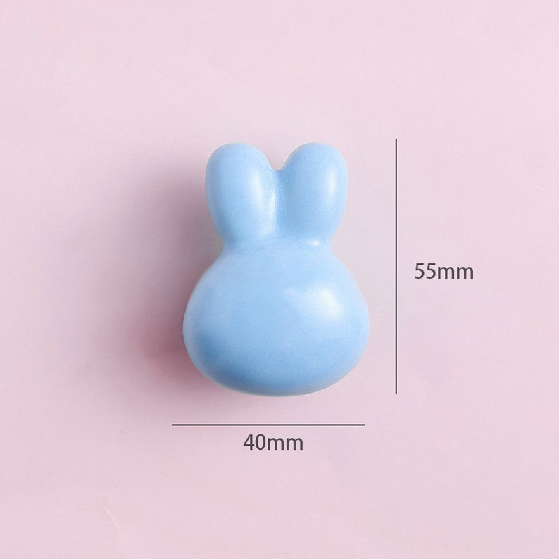 May include: A light blue ceramic bunny-shaped knob, measuring 40mm wide and 55mm tall.