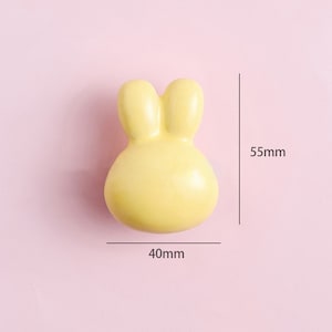 May include: A yellow ceramic bunny-shaped door knob, measuring 40mm wide and 55mm tall.