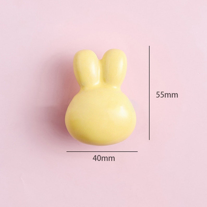 May include: A yellow ceramic bunny-shaped door knob, measuring 40mm wide and 55mm tall.