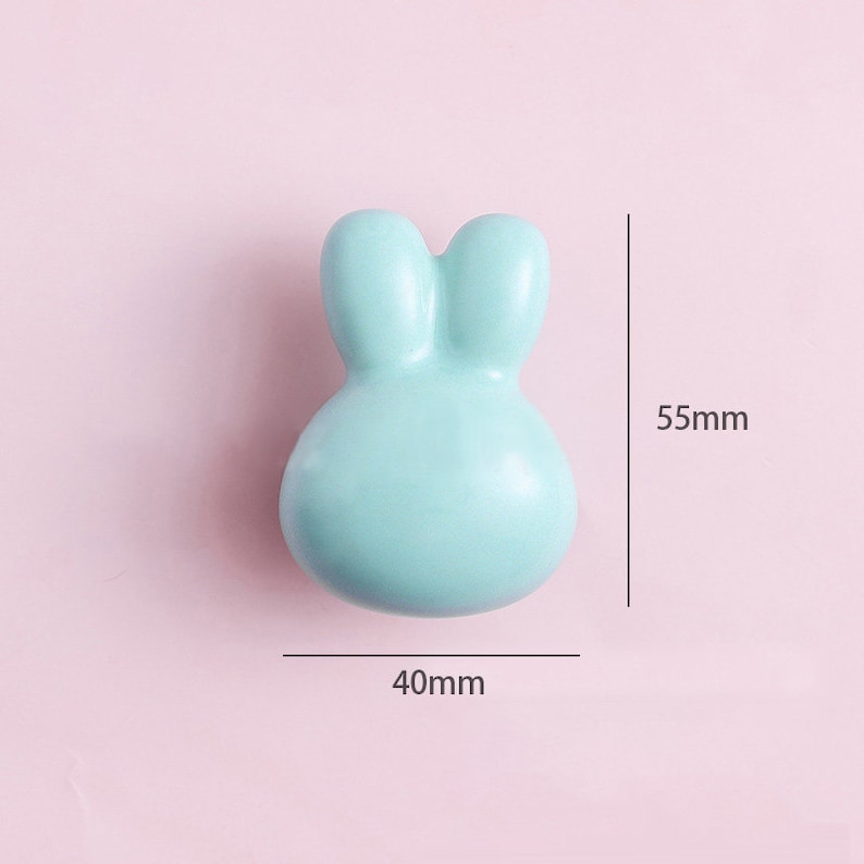 May include: A light blue ceramic bunny-shaped door knob with a 40mm width and 55mm height.