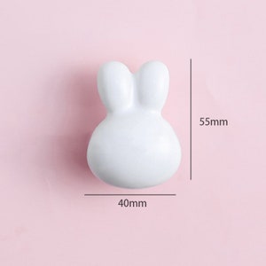 May include: White ceramic bunny-shaped door knob with a 40mm width and 55mm height.