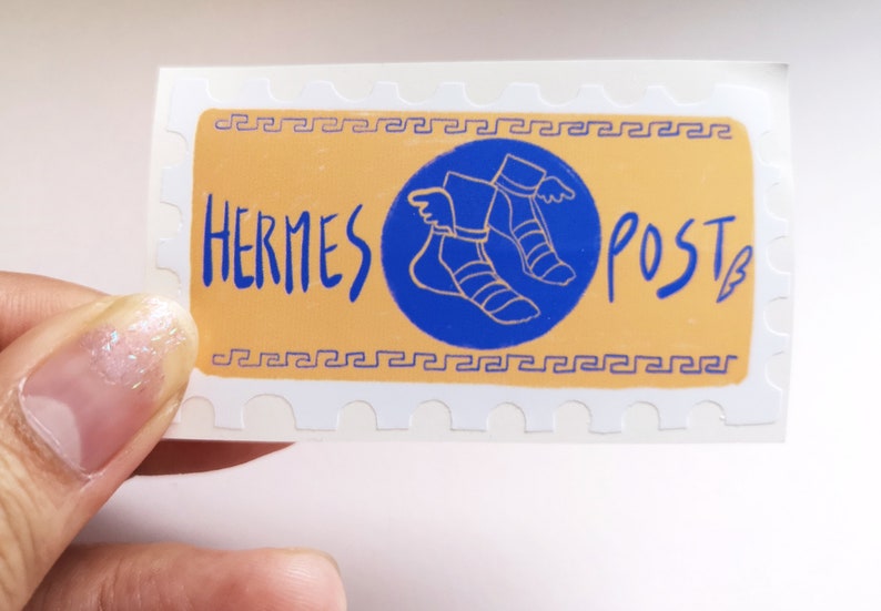 May include: A white sticker with a yellow background and a blue circle containing a stylized image of winged sandals. The text "HERMES POST" is written in blue on the sticker.
