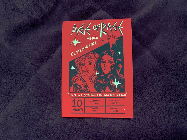 May include: A red poster with black text and illustrations. The poster is titled "Age of Rage" and features two women, Medea and Clytemnestra. The text reads "Hate is a bottomless cup, I will pour and pour." The poster also lists locations and dates: Olympus 1114 BC, Colchis 1145 BC, Tartarus 1128 BC, Argos 1125 BC.
