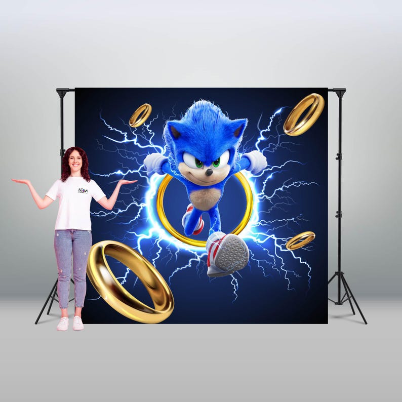 May include: A blue and yellow Sonic the Hedgehog backdrop with a blue hedgehog running through a golden ring. The backdrop is against a black background with blue lightning bolts.