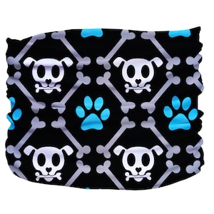 May include: Black and white patterned fabric with a repeating design of dog bones, paw prints, and dog skulls. The fabric is blue, white, and black.