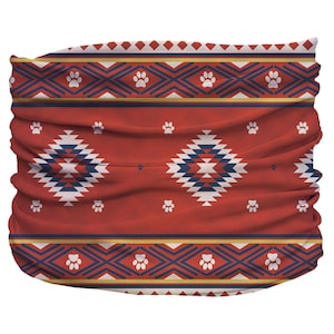 May include: Red, blue, and white patterned neck gaiter with paw prints. The pattern is a geometric design with a southwestern style.