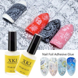 May include: A collection of nail art supplies, including bottles of Star Glue and various nail art designs. The nail art designs feature intricate patterns in red, black, and pink, along with examples of nail foil art.