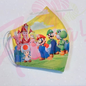 May include: A yellow, green, and pink face mask with a cartoon image of Mario, Luigi, Peach, Toad, and Yoshi in front of a pink castle.