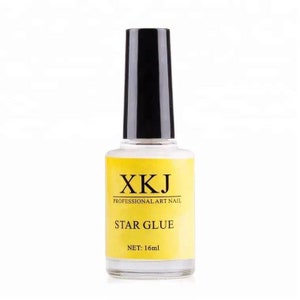 May include: A clear glass bottle of nail art glue with a black cap. The bottle has a yellow label with the text "XKJ PROFESSIONAL ART NAIL STAR GLUE" and "NET: 16ml".