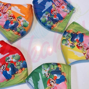 May include: Five colorful face masks with a Mario Brothers theme. The masks feature Mario, Luigi, Peach, Toad, and Yoshi. The masks are made of a soft, breathable fabric and are perfect for everyday use.