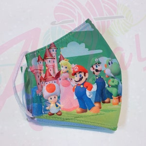 May include: A green, blue, pink, and white face mask with a cartoon image of Mario, Luigi, Peach, Toad, and Yoshi in front of a castle.