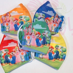 May include: Five colorful face masks featuring a cartoon image of Mario, Luigi, Peach, Toad, and Yoshi. The masks are made of a soft, breathable fabric and are perfect for everyday use.