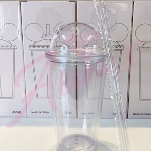 May include: Clear plastic cup with a dome lid and a straw. The cup has a Mickey Mouse ear design on the lid. The cup is 450 ml and made in China.