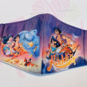 May include: A purple, blue and yellow face mask with a Disney Aladdin Jr. design. The mask features images of Aladdin, Jasmine, Abu and Genie.
