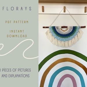 May include: A macrame wall hanging in a semi-circular shape, featuring blue, green, and cream tones. It has a wooden dowel and fringe detailing. The wall hanging is suspended by a cream cord. The image also includes text that says "FLORAYS PDF PATTERN INSTANT DOWNLOAD".