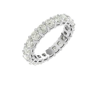 Puede incluir: Un anillo de eternidad plateado con una fila continua de piedras preciosas redondas y claras. La banda del anillo es de plata y tiene un diseño detallado y calado. Las piedras están espaciadas uniformemente.