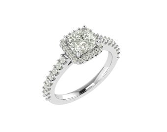 May include: A silver engagement ring with a square-cut center stone surrounded by a halo of smaller stones. The band is also adorned with small, sparkling stones. The ring is set against a white background.