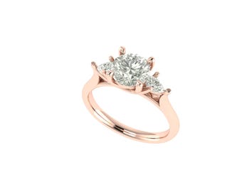 May include: Rose gold engagement ring featuring a large, round-cut diamond center stone, flanked by two smaller pear-shaped diamonds. The ring has a delicate band and a classic, elegant design. The diamonds sparkle against the warm hue of the rose gold.