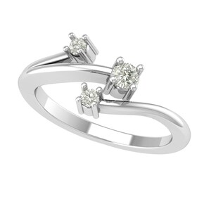 May include: A silver ring with three clear, round gemstones. The ring's band curves gracefully, with the gemstones set in individual prongs. The design is modern and elegant, suitable for everyday wear or special occasions.