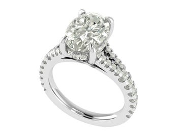 May include: A white gold engagement ring with a large, oval-cut diamond as the focal point. The band is embellished with smaller diamonds, adding to the ring's brilliance and design. The ring is set against a white backdrop.
