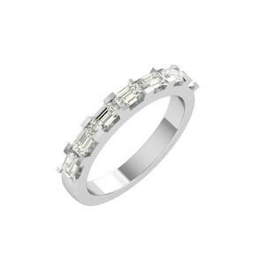 May include: A silver ring featuring a series of rectangular-cut gemstones set across the top. The gemstones are clear and sparkling, set in a channel setting. The ring has a polished, reflective surface.