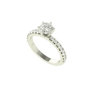 Może przedstawiać: Pierścionek zaręczynowy z brylantem, z dużą, okrągłą, przezroczystą kamieniem osadzonym w czteroramiennej oprawie. Oprawa jest w jasnym srebrnym kolorze i jest inkrustowana małymi, przezroczystymi kamieniami. Na białym tle.