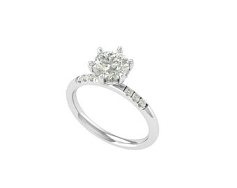 May include: A silver engagement ring with a large, round, clear diamond center stone. The band features smaller diamonds set along the side. The ring is set against a white background.