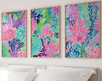May include: A set of three rectangular wall art prints in light wood frames, each featuring a vibrant, dense pattern of coral reef elements in shades of hot pink, bright green, turquoise, and navy blue against a light background.