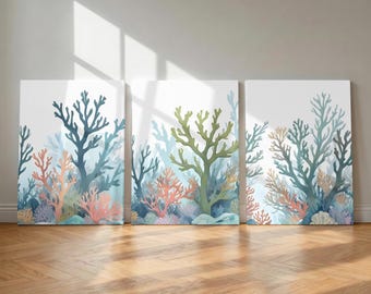May include: A triptych of three rectangular wall art canvases featuring a watercolor-style illustration of an underwater coral reef. The artwork displays various coral formations in shades of deep blue, sage green, coral pink, and soft lavender.