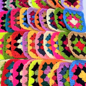 May include: A collection of colourful crocheted granny squares in various colours, including red, green, blue, yellow, pink, and purple.
