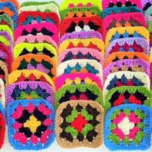 May include: A collection of colourful crocheted squares, each with a different pattern and colour combination. The squares are arranged in rows, creating a vibrant and textured display.