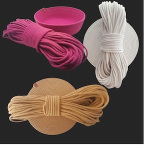May include: A selection of coiled rope in fuchsia, cream, and tan, with a fuchsia basket. The rope is tightly wound and displayed on circular bases. Ideal for crafts or DIY projects, with measurements in centimetres.