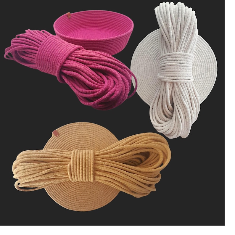 May include: A selection of coiled rope in fuchsia, cream, and tan, with a fuchsia basket. The rope is tightly wound and displayed on circular bases. Ideal for crafts or DIY projects, with measurements in centimetres.