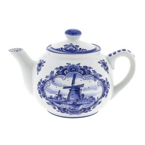 May include: A white ceramic teapot with a blue and white floral design and a windmill scene. The teapot has a lid and a handle.