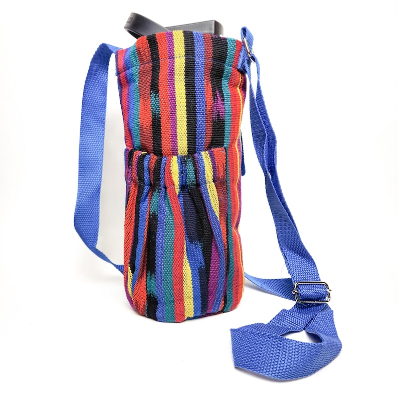 May include: A colorful striped fabric water bottle carrier with a blue adjustable strap. The carrier has a drawstring closure at the top.