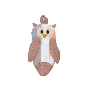 May include: A brown and white striped owl plush toy with a loop for hanging. The owl has large, black eyes and a yellow beak.