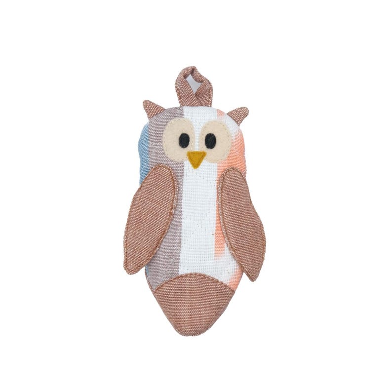 May include: A brown and white striped owl plush toy with a loop for hanging. The owl has large, black eyes and a yellow beak.