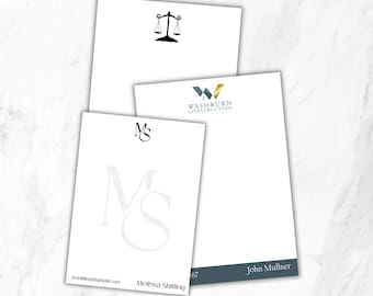 May include: Three white stationery sheets with custom branding. One features a black scale of justice icon. Another displays the Washburn Construction logo and John Mullner. The third shows the initials MS and Melissa Shilling.