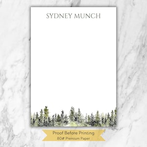 May include: White stationery with the name "SYDNEY MUNCH" in dark green at the top. A watercolor forest scene in shades of green and gray adorns the bottom. The text "Proof Before Printing" and "80# Premium Paper" are at the bottom.