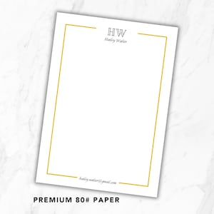 May include: A rectangular sheet of white 80# paper featuring a thin gold border. The top center displays the initials HW above the name Hailey Walter in black text. The bottom center includes the email address hailey.walter@gmail.com in black.