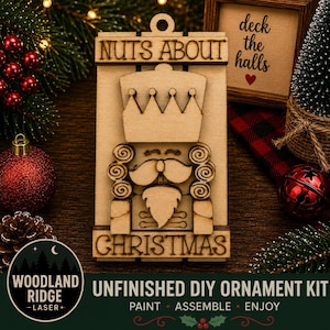 May include: A light-colored wooden nutcracker ornament featuring a crown, mustache, and beard. The text NUTS ABOUT CHRISTMAS is engraved on the top and bottom sections. The ornament has a hole at the top for hanging and is unfinished for DIY projects.