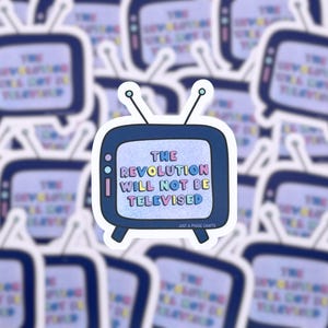 May include: A white sticker with a blue and white television screen design. The screen says "The Revolution Will Not Be Televised" in colorful letters. The sticker is from Just A Phase Crafts.
