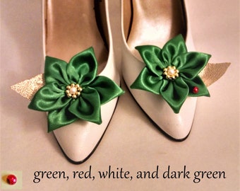 May include: A pair of white high-heeled shoes with green satin bows and a gold accent. The shoes have the text "Renetti Made in Japan" on the inside.