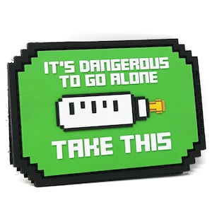 May include: Green and black pixelated patch with the text "It's dangerous to go alone. Take this." and a pixelated image of a white and yellow item.